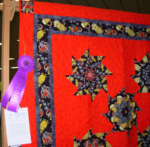Bright pinwheel quilt with a blue ribbon