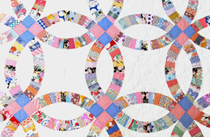 quilt made with blue rings on a white background